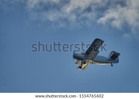 British old aircraft flying above Riga. airplane biplane with piston engine and propeller.