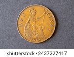 A British one penny coin dated 1936. Pre-decimal copper coin numismatics.