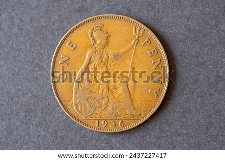 A British one penny coin dated 1936. Pre-decimal copper coin numismatics.