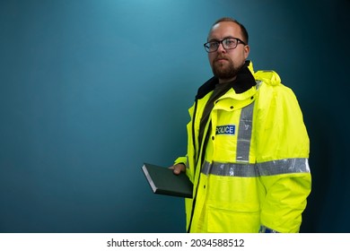 British Police Officer In Reflective Uniform Isolated On Background.