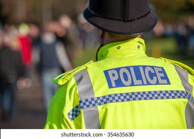 British Police Officer Uniform With High Visable Yellow Jacket