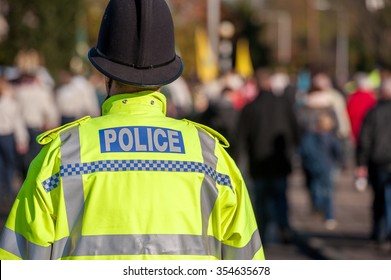 British Police Officer Uniform With High Visable Yellow Jacket