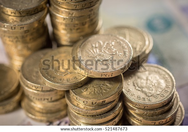 British Pound Coins against a background of
British assorted bank
notes

