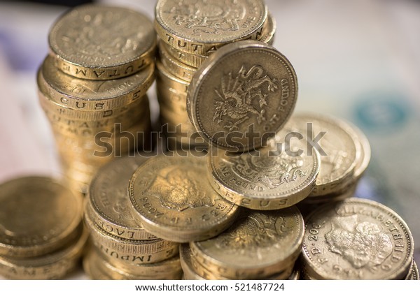 British pound Coins against a background of\
British assorted bank\
notes\
\
