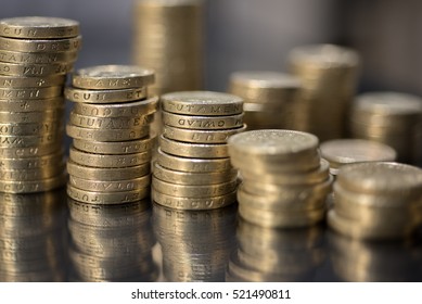 British pound Coins Close Up Macro studio shot against a reflective black background