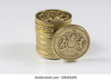 British pound coins up close macro studio shot against a shiny reflective White background