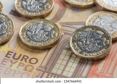 British Pound Coins On A Euro Banknote. Close Up View.