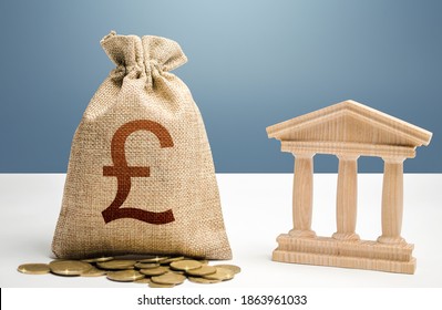 British Pound Sterling Money Bag And Bank Government Building. Budgeting, National Financial System. Support Businesses In Crisis. Lending Loans, Deposits. Monetary Policy. Resource Allocation.