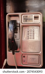 british public pay phone inside a red telephone box