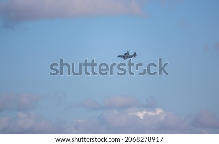 
British RAF Lockheed Martin C-130J Hercules aircraft on a military exercise cargo parachute drop run over Salisbury Plain Training Area, UK
