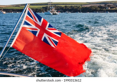 British Red Ensign Flag Flying In The Wind On The Bow Or Back Of A Sailing Boat, Yacht Or Ship