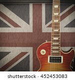 British Rock Invasion concept - detail close up of a guitar leaning against an amplifier with British Union Jack flag on the cabinet on stage at a concert - vintage toned Instagram style