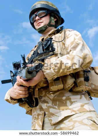 British Royal Commando in desert uniform holding his rifle