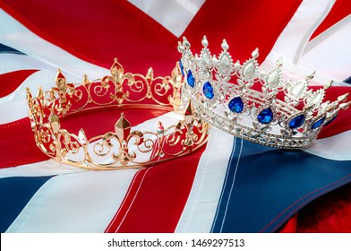 British royals, royal coronation and monarchy concept theme with a gold king crown and a silver queen tiara with the UK flag called the union jack in the background