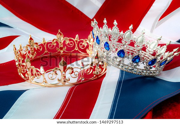 British royals, royal\
coronation and monarchy concept theme with a gold king crown and a\
silver queen tiara with the UK flag called the union jack in the\
background