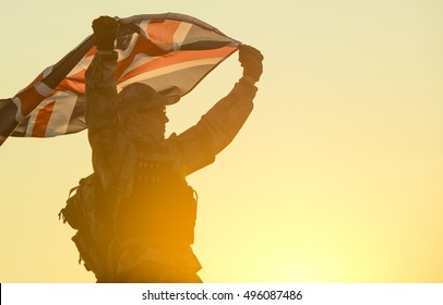 British Soldier with UK Flag in His Hands. Military Concept.