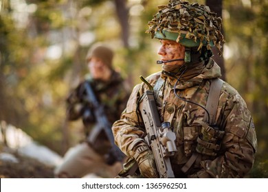 British special forces soldier with weapon take part in military maneuver. war, army, technology and people concept.