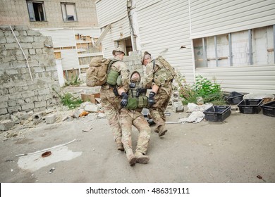British special forces soldiers with weapons during the rescue operation. war, army, technology and people concept.