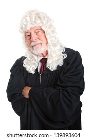 British Style Judge, In A Wig, With His Arms Crossed And A Skeptical Expression.  Isolated.