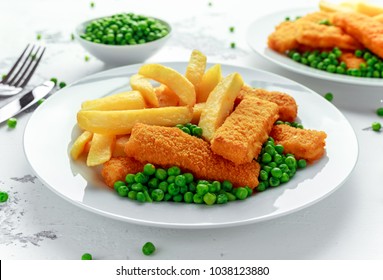 British Traditional Fish Finger And Chips With Peas And Tartar Sauce In A White Plate.