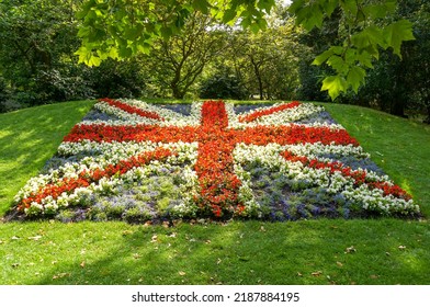 British Union Jack Flag Made From Red, White And Blue Flowers. Garden Designs In Public Park.