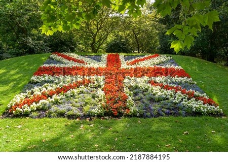British Union Jack flag made from red, white and blue flowers. Garden designs in public park.