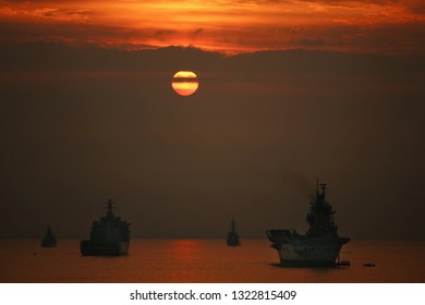 British War Ships On The Open Ocean At Sunset.