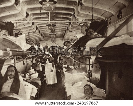 British WW1 wounded evacuated from France in a hospital train. 1914-18. Ambulances will transfer them to the base hospital.