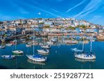 Brixham Devon beautiful harbour with boats with blue sky England UK