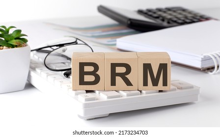 BRM Business Reference Model written on wooden cube on keyboard with office tools