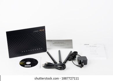 Brnenec, Czech Republic - January 31, 2020: Wifi Router Asus RT-AC68U, Power Cable, Quick Start Guide, Three Antennas. Asus Is A Taiwanese Computer And Electronics Company. 