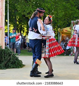Brno - Bystrc, Czech Republic, June 25, 2022.  Traditional Czech feast. Folk Festival. Girls and boys dancing in beautiful costumes. An old Christian holiday, a day of abundance, joy and prosperity.