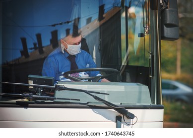 Brno, Czech Republic - April 23 2020: Resting public transport bus driver wears an cloth face mask. It is recommended wear nonmedical face masks to slow the spread of corona virus.