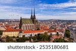 Brno, Czech Republic. Cinematic Aerial view to the Roman Catholic cathedral. Originally medieval in gothic style, many renovations, High towers added in Gothic revival between 1901-1909. Aerial view. 