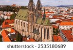 Brno, Czech Republic. Cinematic Aerial view to the Roman Catholic cathedral. Originally medieval in gothic style, many renovations, High towers added in Gothic revival between 1901-1909. Aerial view. 