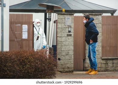 Brno, Czech Republic - March 4 2021: A Man Wearing A Cloth Face Mask Talks To A Healthcare Worker At A Corona Virus Test Site.