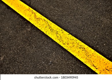 Broad Neon Yellow Band In Diagonal Perspective On A Black Surface, Element Of Road Signage.