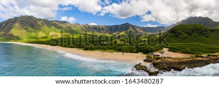 Broad panorama of Makua beach and valley from aerial view over the ocean on west coast of Oahu, Hawaii