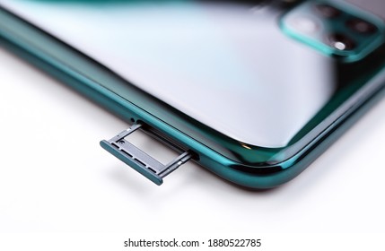 Broadband 5G Mobile Communication Technology Concept : Empty Blank SIM Card Tray  Dual Nano SIM Card Slot On White Background. SIM Card Stores International Mobile Subscriber Identity IMSI Number.
