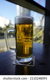 Broadbeach Queensland Australia -October 16 2021: A Tall Mug Of Beer With Frothy Foam.