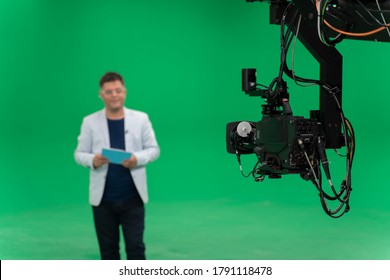 Broadcast Television Studio Camera In Greenscreen Studio Room With Announcer On The Ceiling.