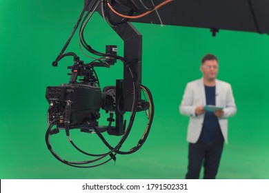 Broadcast Television Studio Camera In Greenscreen Studio Room With Announcer On The Ceiling.