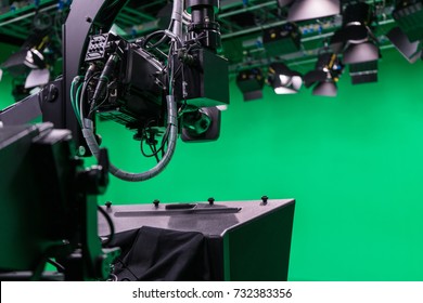 Broadcast Television Studio Camera In Greenscreen Studio Room With LED Lights On The Ceiling.