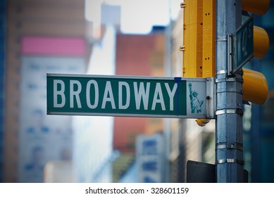 Broadway road sign in Manhattan New York City with skyscrapers.