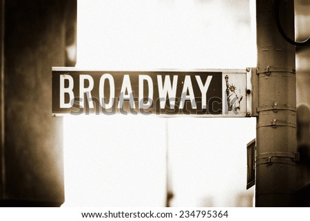Broadway Street Sign in New York City, with Statue of Liberty 