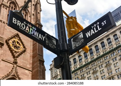 Broadway And Wall Street Intersection In Manhattan With Trinity Church In The Background.