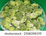 Broccoli Background Concept. Vegetables over broccoli. from the top view. Broccoli in bowl high angle view. Fresh raw broccoli as background, top view.

