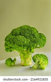 Broccoli cabbage in the form of a green tree on a mustard background with parts