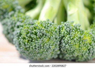 Broccoli Cabbage On A Light Background Before Cooking Closeup. Shallow Depth Of Field