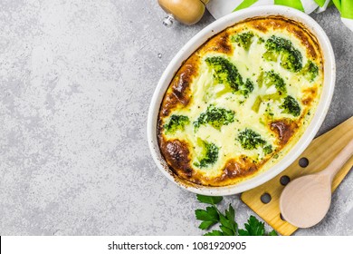 Broccoli cheddar egg casserole in baking dish on concrete background. Top view, copy space.